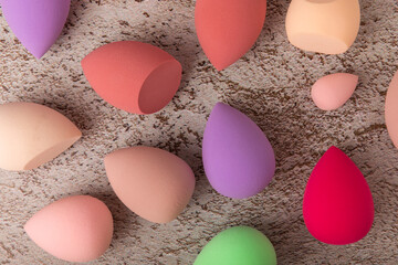 Wall Mural - Beauty blender. Colorful beauty sponges on a marble background. Cosmetic tool for applying foundation, concealer. Place for text. Place to copy.