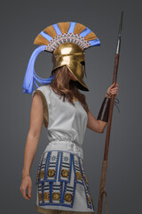 Wall Mural - Shot of isolated on grey background greek soldier woman holding spear.