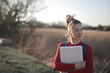 © olly - young woman with a laptop in her hands in the countryside