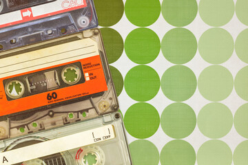 Wall Mural - three colorful vintage audio compact cassettes in front of seventies retro wallpaper