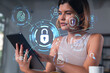 © VideoFlow - Smiling businesswoman in casual wear holding tablet device touching it at office workplace. Concept of distant work, business education, information technology. Lock icons hologram