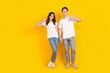 © deagreez - Full length photo of sweet confident husband wife dressed white t-shirts showing thumbs up empty space isolated yellow color background