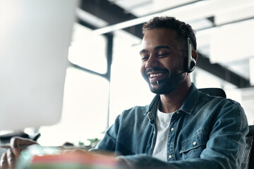 Canvas Print - Happy young male customer support executive working in office