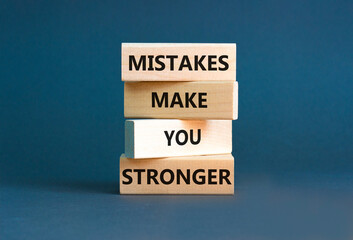 Wall Mural - Mistake make stronger symbol. Concept words Mistakes make you stronger on wooden blocks. Beautiful grey table grey background. Business mistake make stronger concept. Copy space.