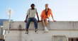 © Siphosethu F/peopleimages.com - Rooftop, relax and friends for social conversation together in cool wind, sunshine and blue sky mock up space for advertising gen z youth aesthetic. Happy black people couple on urban city building