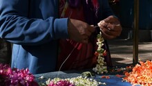 Indian Woman Making A Crossandra And Jasmine Garland At A Roadside Shop