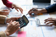 © crizzystudio - Teamwork of asian business people discussing and calculating with calculator on evaluation data in conference room. with the growth and pointing to the chart graph financial account.
