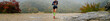 girl athlete running mountain marathon in rain
