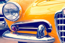 The Hood, Bumper, Headlight And Radiator Of A Stylish Retro Yellow Car