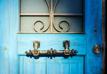 Old Ancient Iron Door Handle On A Wooden Blue Door. Selective Focus
