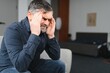 © Serhii - Headache. Senior Man Suffering From Migraine Pain Massaging Temples Sitting At Home. Healthcare, Health Problems In Older Age Concept