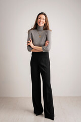 full length studio portrait of attractive brunette haired woman posing at isolated background