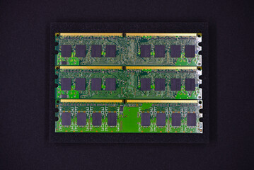 Wall Mural - Green RAM strips on black foam. Computer chips close-up. Microchips and memory chips.