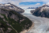 Fototapeta Morze - Aerial view of the Norris Glacier, as it makes its way down out of the mountains near Juneau, Alaska. 