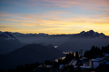 Wall Mural - Orange sunset on alpine mountains and lake