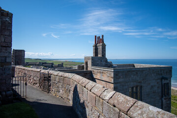 Wall Mural - Bamburgh Castle walls looking out towards sea and coast. Northumberland, UK