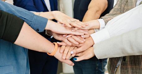 women's and men's hands folded together. the concept of teamwork and support.