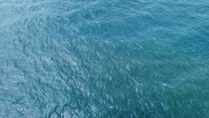 Blue water texture. Top view of the ocean surface with waves