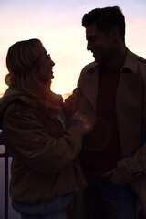 Poster - Silhouette of lovely couple looking at each other at sunset