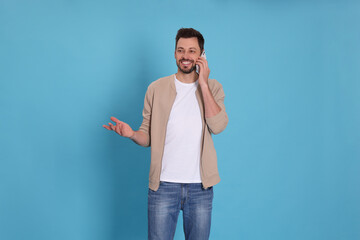 Poster - Man talking on phone against light blue background