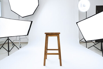 Canvas Print - Interior of modern photo studio with bar stool and professional lighting equipment