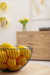 Sticker - Spring interior. Bowl of lemons on wooden table in room, closeup with space for text