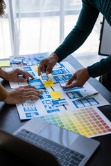 Wall Mural - asian young people working together on mobile application software design project. brainstorming. in