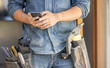 © Lumeez/peopleimages.com - Closeup, hands and man with smartphone, maintenance and research for instructions, deadline or schedule. Zoom, male or handyman with cellphone, social media or typing for connection or search on site