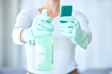 Sticker - Woman, hands and detergent for housekeeping, cleaning or disinfect with latex gloves in sanitary home. Hand of female cleaner holding sanitizer bottle and sponge for domestic work or clean hygiene