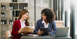 © Nuttapong punna - Two businesswoman discuss investment project working and planning strategy with tablet laptop computer in modern office..