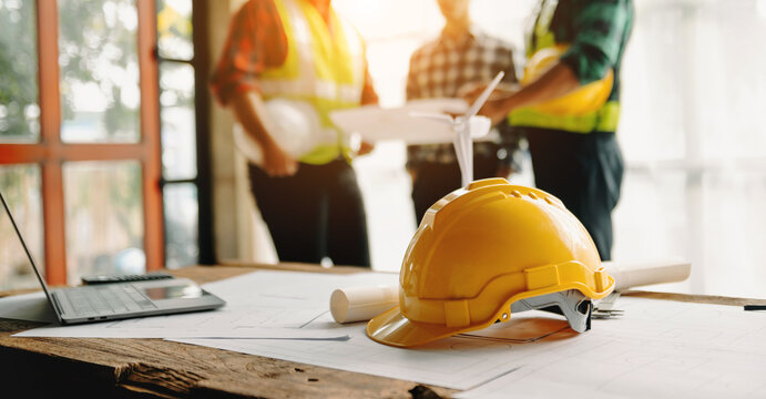engineer teams meeting working together wear worker helmets hardhat on construction site in modern c