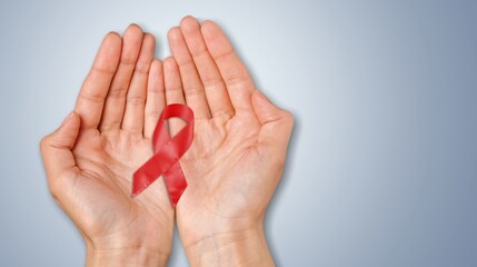 Sticker - Hand hold a red ribbon on background