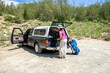© Cavan Images - Woman loading luggage into truck at Piute Pass trailhead, Eastern Sierra, Bishop, California, USA
