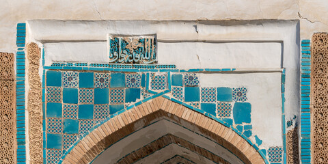 Wall Mural - Detail view of ancient islamic art on entrance portal of heritage shrine at Mazar-i-Sharif near Panjakent or Penjikent, Sughd region, Tajikistan