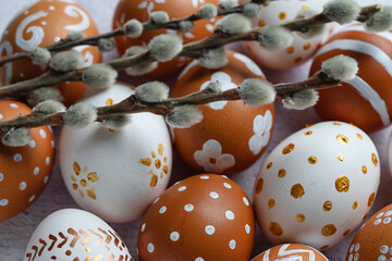 Wall Mural - Painted Easter eggs and willow branches on light table, closeup