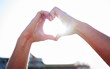 © Anela R/peopleimages.com - Love, heart and hands with sunshine, support and collaboration with light, mockup and outdoor. Closeup, zoom and sign with lens flare, community and peace with wellness, care and kindness outside