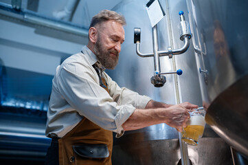 Brewery master quality tasting of craft beer at production facility