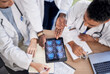 © Jordan C/peopleimages.com - Tablet screen, brain and doctors in neurology research, internship training and teamwork for healthcare solution. Assessment, cancer analysis and xray of medical students or professional people above