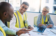 © Jordan C/peopleimages.com - Architect, laptop and meeting for industrial construction, team planning or idea strategy at office. Group of diverse engineers or contractors discussing floor plan for project layout or architecture