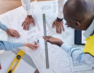 Architect, hands and blueprint in meeting above for construction, team planning or strategy for project layout at office. Hand of group in engineering discussing floor plan drawing for architecture