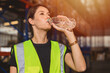 © Quality Stock Arts - health care woman worker drinking clean water while working in hot place for refresh and personal healthy