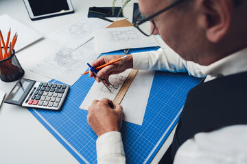 Wall Mural - Mature man working on architectural project in office