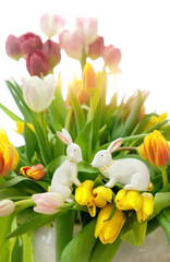 Wall Mural - decorative Easter Bunny with tulip flowers close up on abstract white background. festive composition for Easter holiday, spring season. template for design.