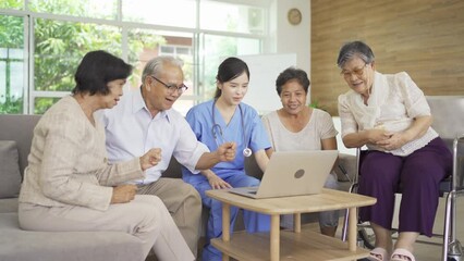 Wall Mural - An Asian nurse talking to a group of old elderly patient or pensioner people smiling, relaxing, having fun together in nursing home. Senior lifestyle activity recreation. Retirement. Health care