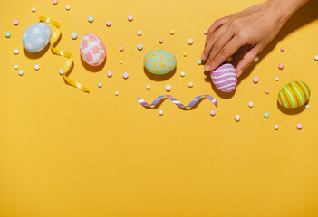 Wall Mural - Happy easter Colourful of Easter eggs on yellow background. Greetings and presents for Easter Day celebrate time. Flat lay ,top view, copy space.