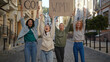 © RZ Images - Outdoor portrait of women activists protest with Go Woman posters