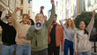 © RZ Images - Woman leader at protest shouting slogans into megaphone. Multiethnic activist people at city streets