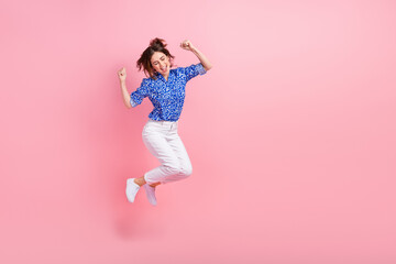 Canvas Print - Full length photo of shiny lucky woman dressed blue blouse jumping high rising fists empty space isolated pink color background