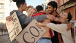 © RZ Images - Young protester with USA flag walks to multiracial activists and hugging them. Mass protest concept