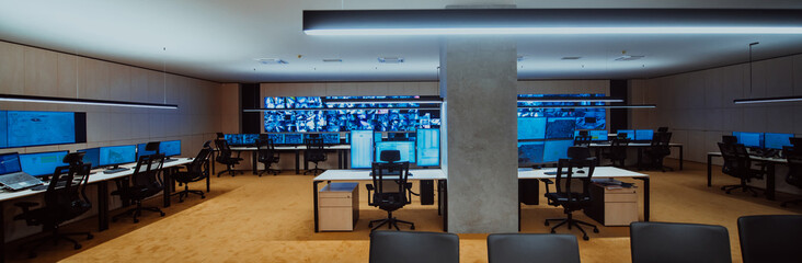 Wall Mural - Empty interior of big modern security system control room, workstation with multiple displays, monitoring room with at security data center Empty office, desk, and chairs at a main CCTV security data